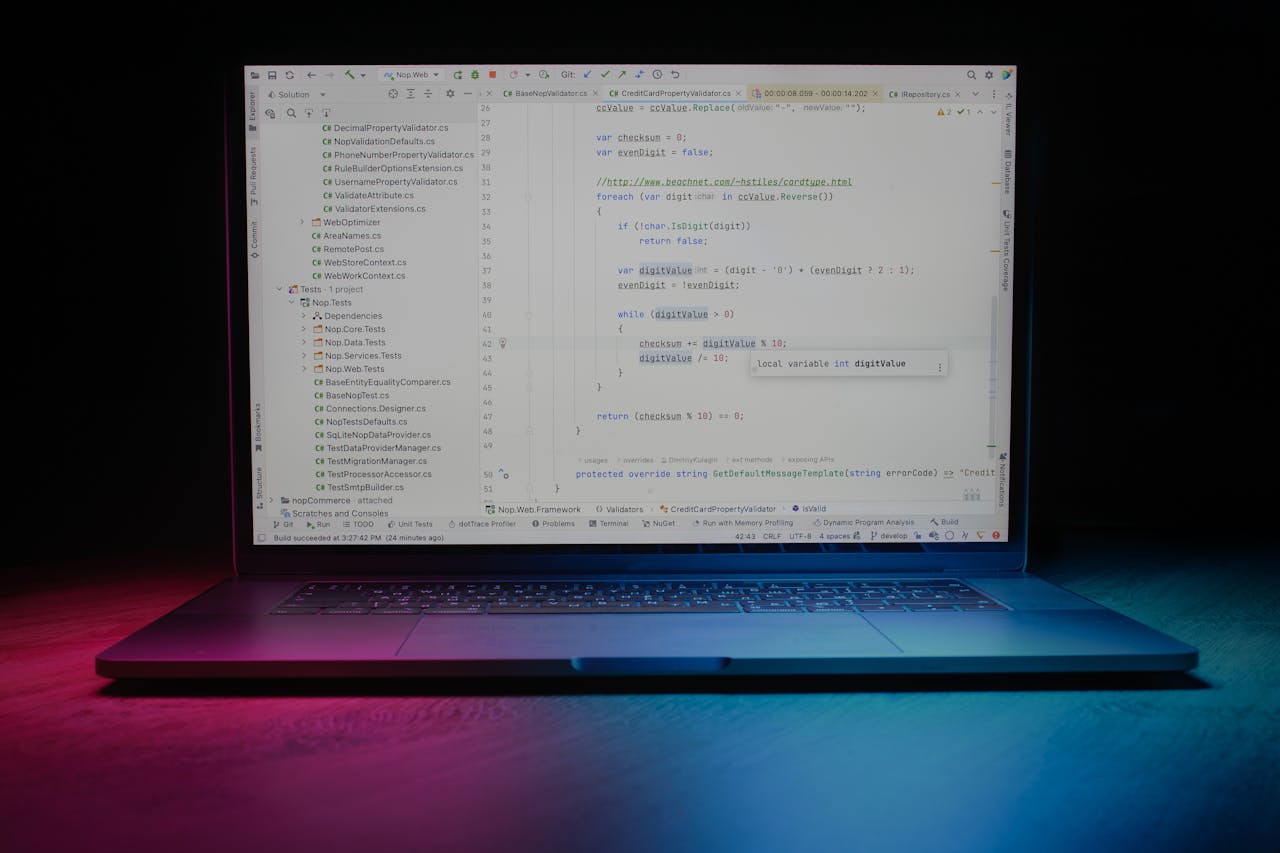 about-img Close-up of a laptop showing code editor under vibrant lighting, ideal for tech themes.